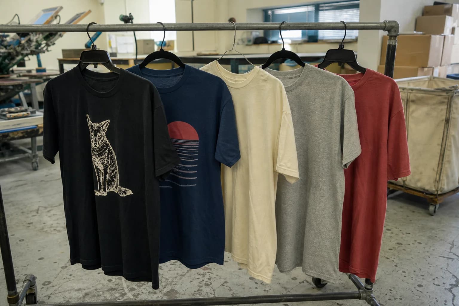 A rack of finished printed shirts in a production studio