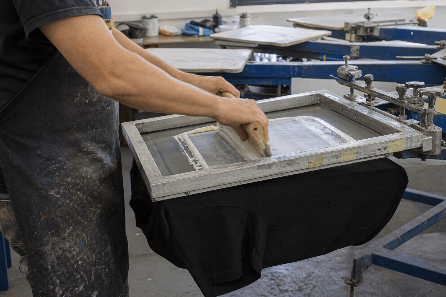 Printer pulling ink across a screen on a manual press